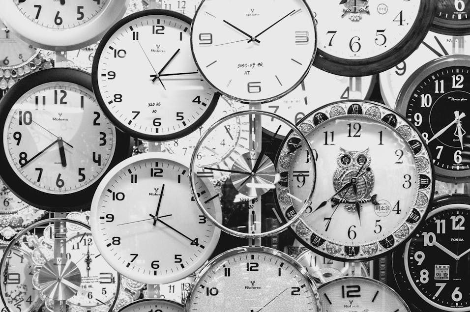 black and white photo of clocks